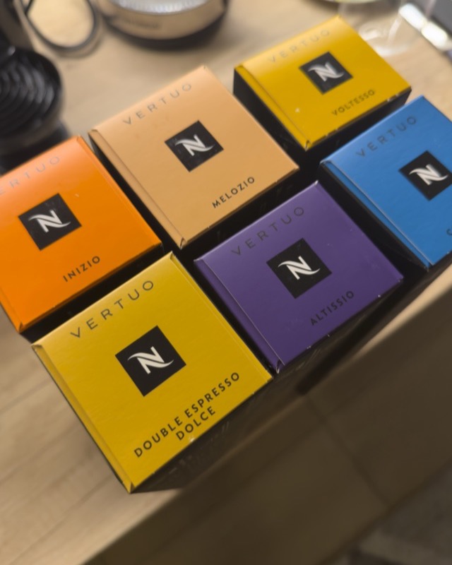 Collection of Nespresso coffee capsules displayed on a kitchen counter with bright colors and labels in a home setting undefined