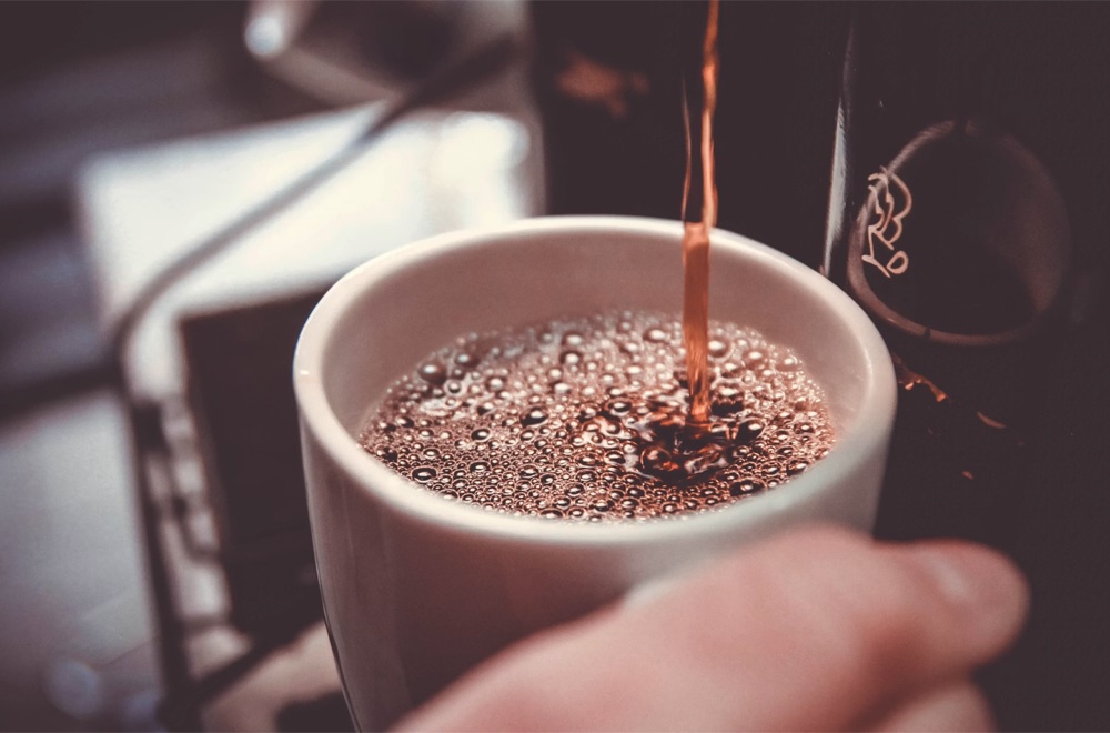 Fresh coffee pouring into a mug